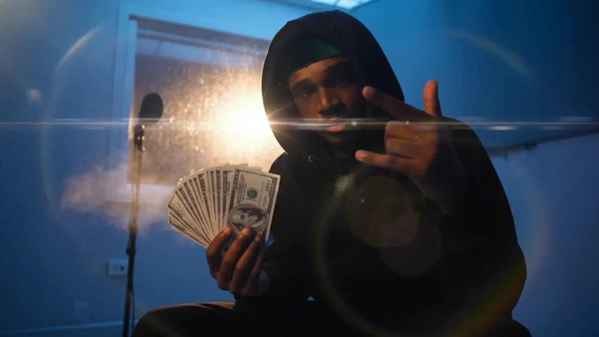 BLVD CO in studio hoodie, holding money stack, showing confidence.
