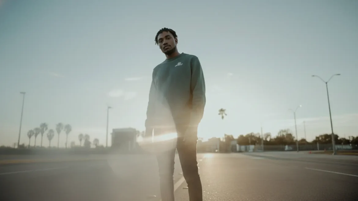 EYAH Official standing on an empty street at sunset