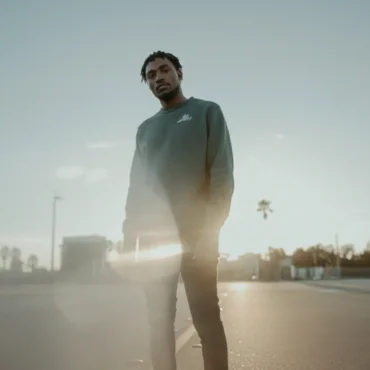 EYAH Official standing on an empty street at sunset