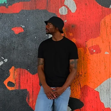 MetaphO stands in front of a graffiti wall in Tampa.