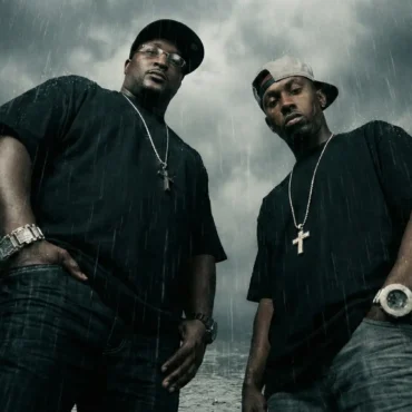 DA-MOVEMENT rappers standing in the rain wearing black t-shirts and chains for All Black Everything single.