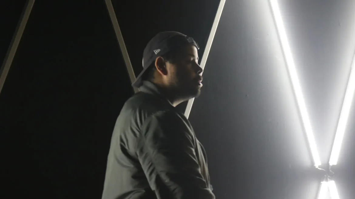 Rapper Kevin King in side profile with neon lights.