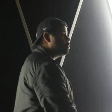 Rapper Kevin King in side profile with neon lights.