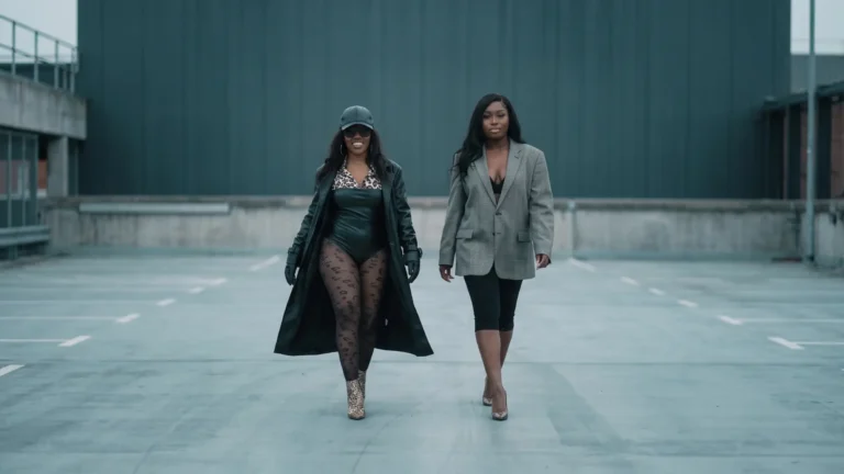 Kyilah and Vanz walking toward camera side by side, both grinning and composed, "No Good"