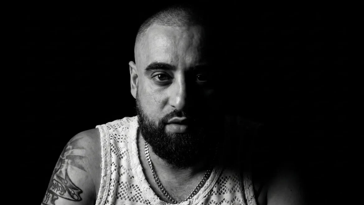 Black and white close-up portrait of eQuivic, direct camera gaze, half the face in shadow, promoting "Day Time"