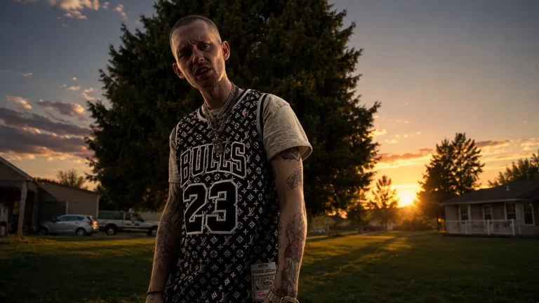 Trevor Drako standing outdoors at sunset in a Bulls jersey and gold chains, promotional photo for "Love with a dancer (Radio Edit)"